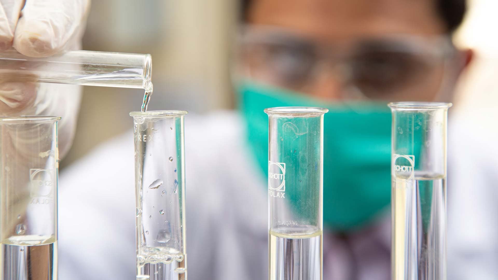 Scientist in lab pouring test tube