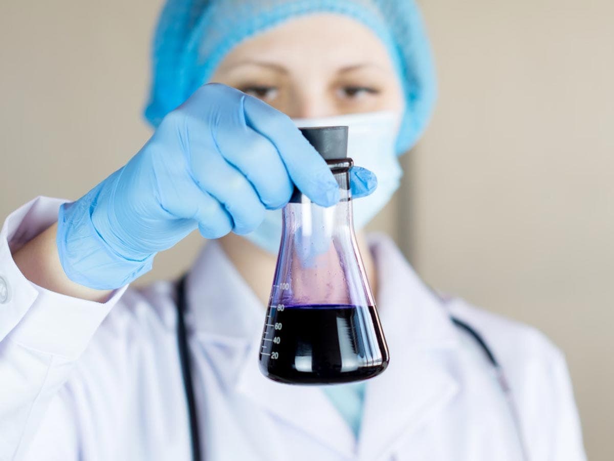 Scientist holding a jar in a lab