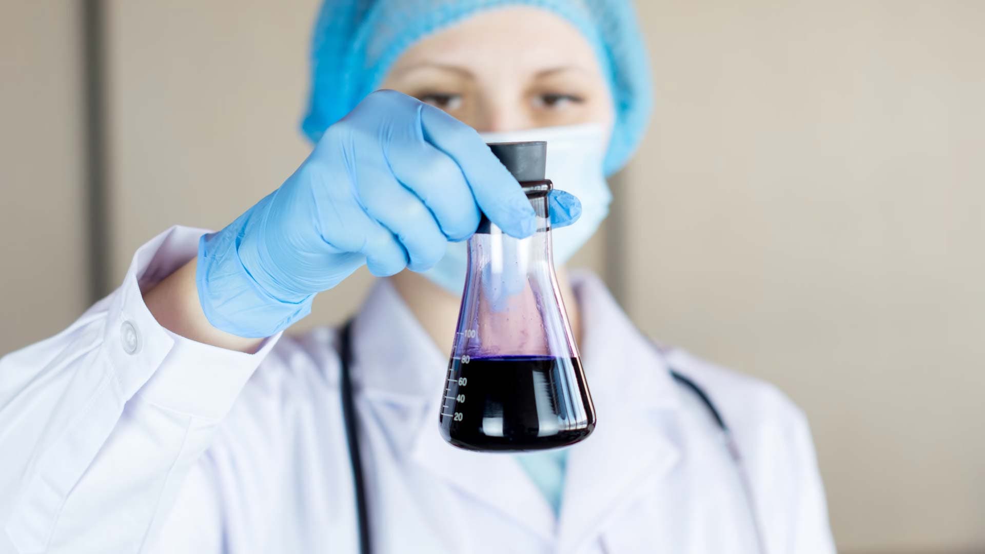 Scientist holding a jar in a lab