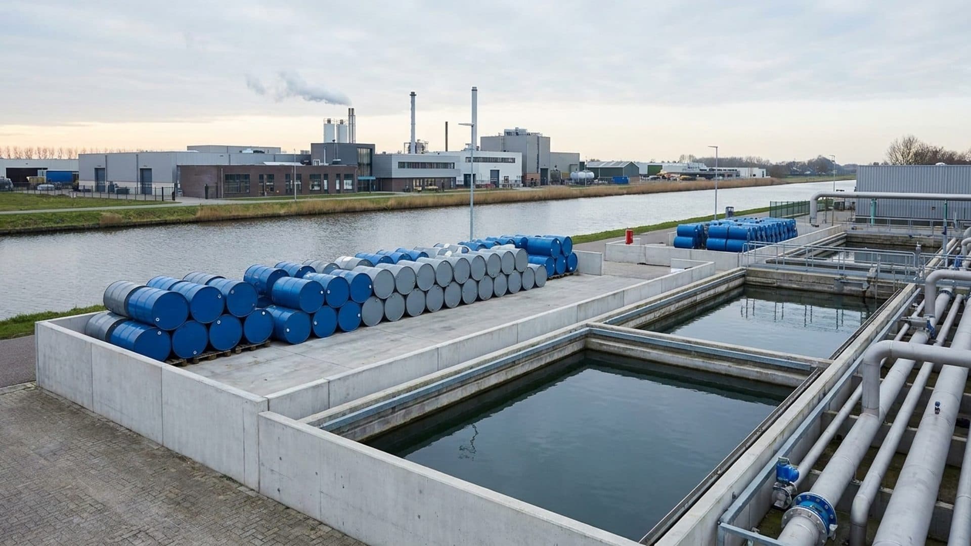 Industrial waste-treatment facility and containment equipment beside a Dutch canal