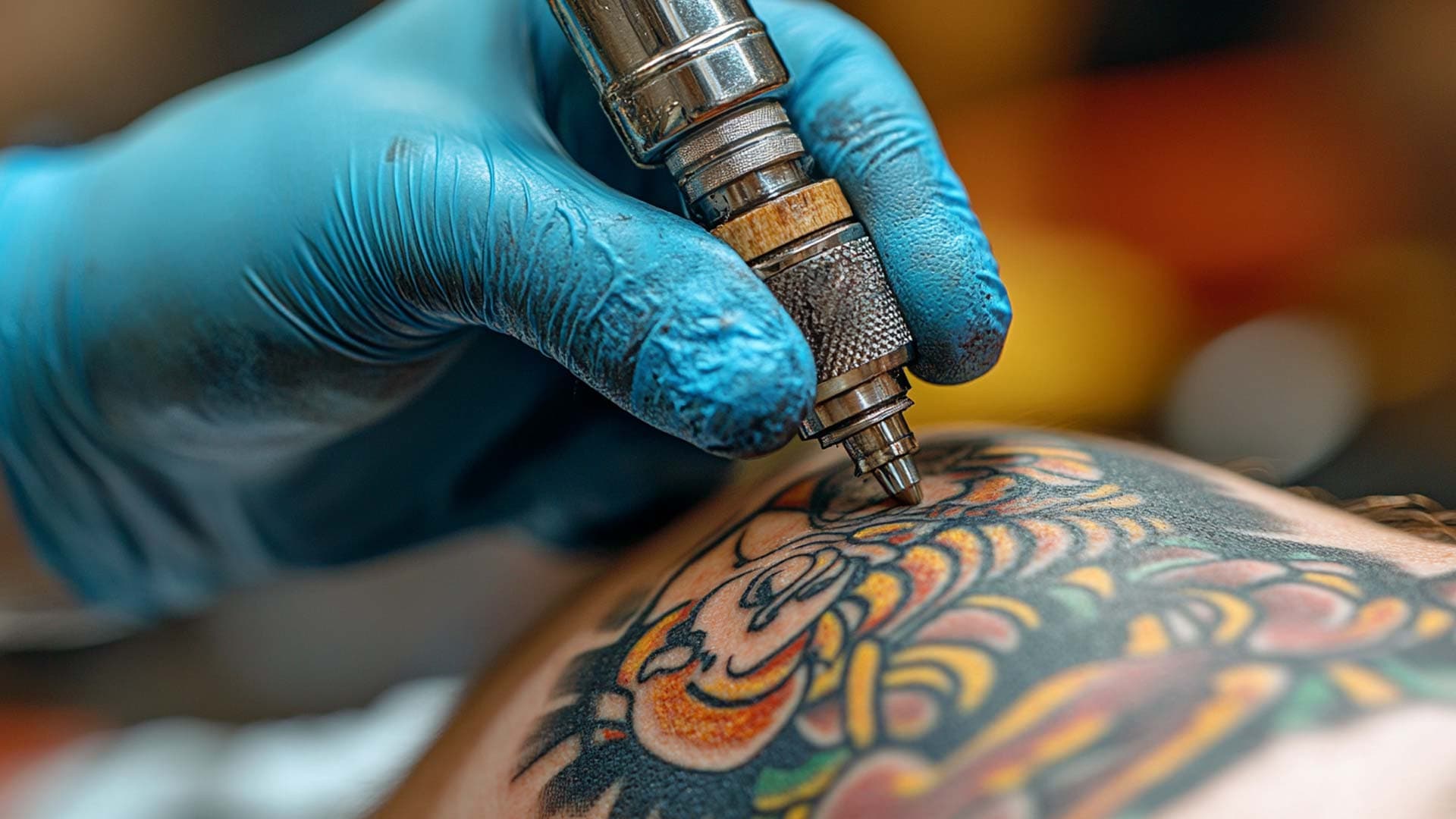 Tattooist tattooing an arm