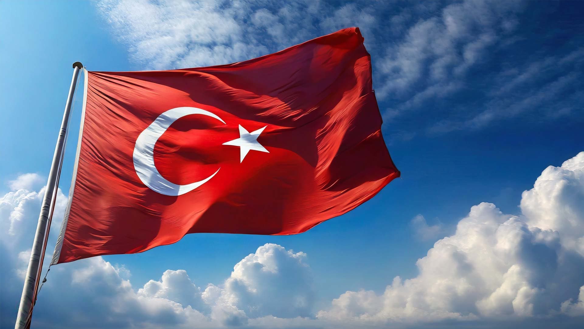 Turkey flag flying against a blue sky