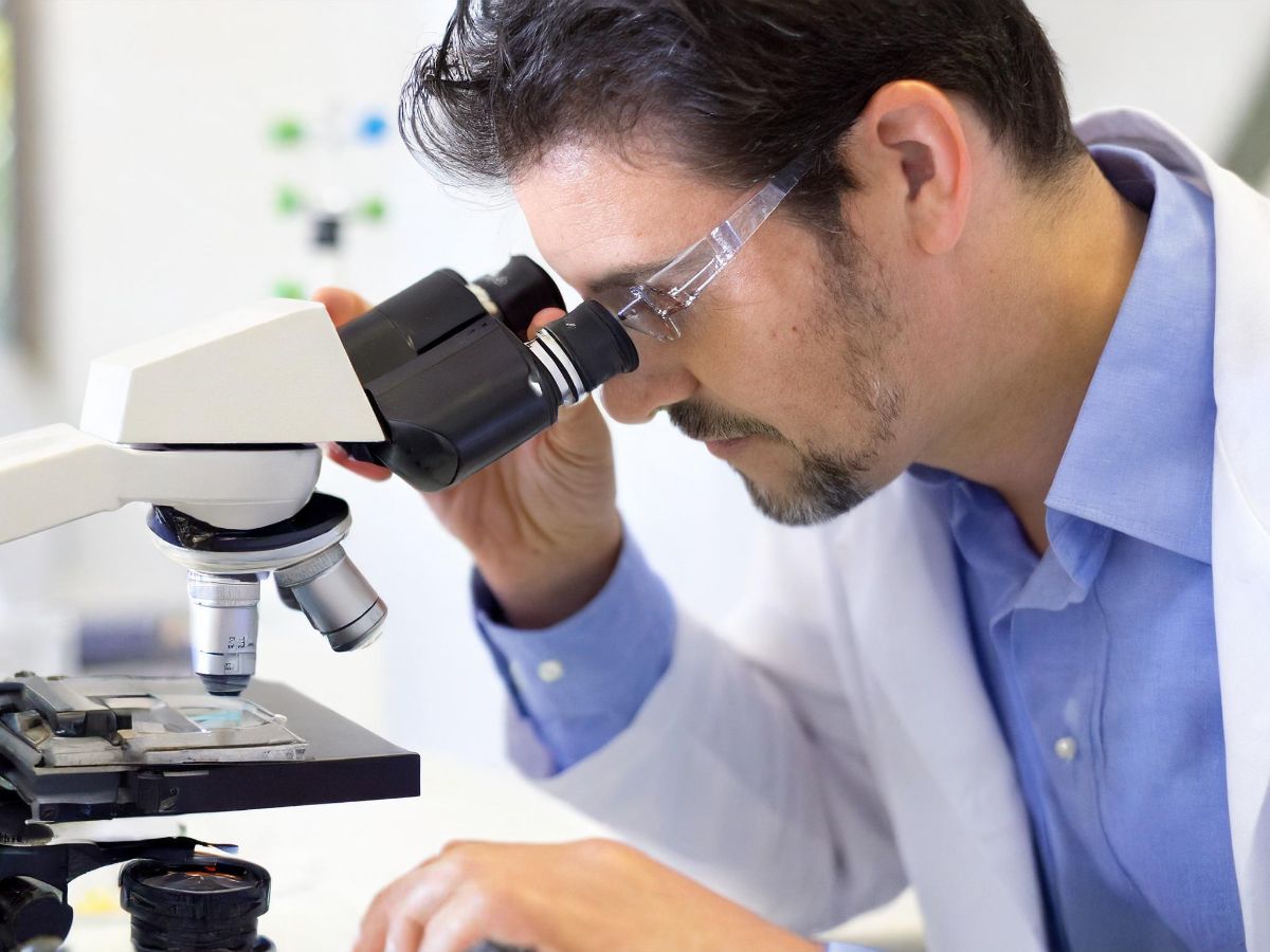 Person using a microscope in a lab